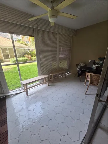 a view of a room with gym equipment and a large window