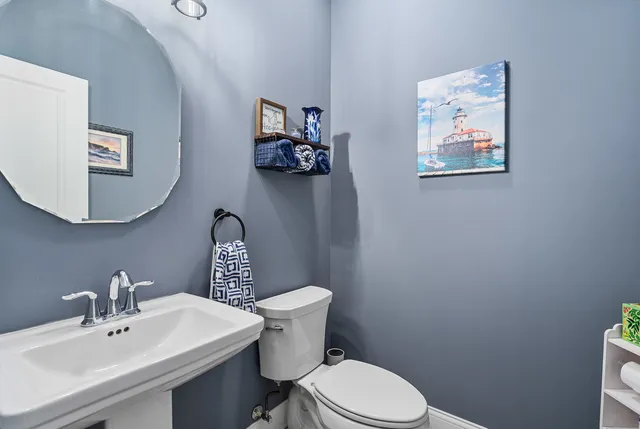 a white toilet sitting next to a bathroom sink