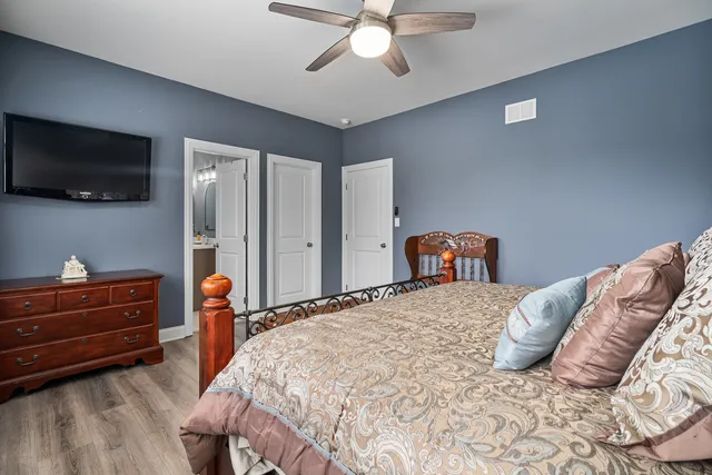 a bedroom with a bed and flat screen tv