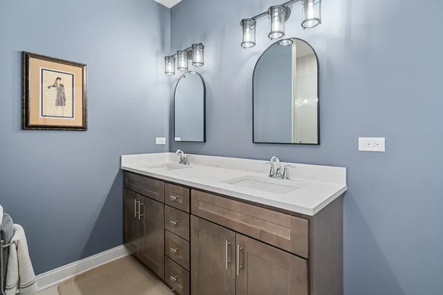 a bathroom with a double vanity sink and a mirror