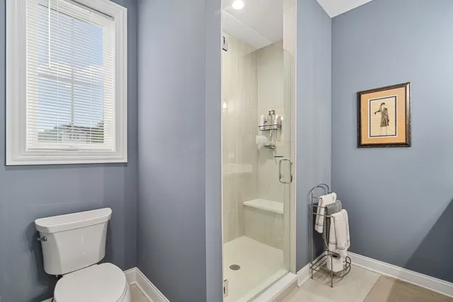 a bathroom with a toilet and a shower