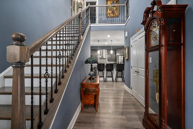 a view of entryway and hall with wooden floor