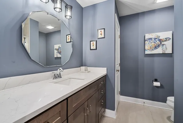 a bathroom with a sink vanity and a mirror