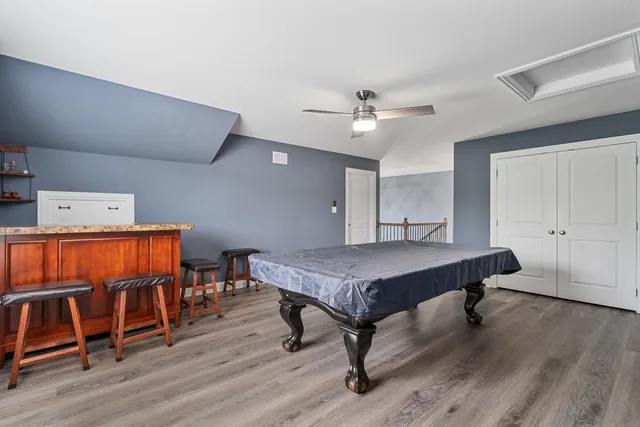 a view of a workspace with furniture and wooden floor