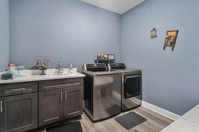 a utility room with sink dryer and washer