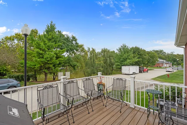 a view of a deck with chairs and wooden fence