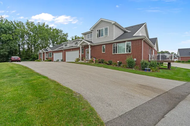 a front view of a house with a garden and plants