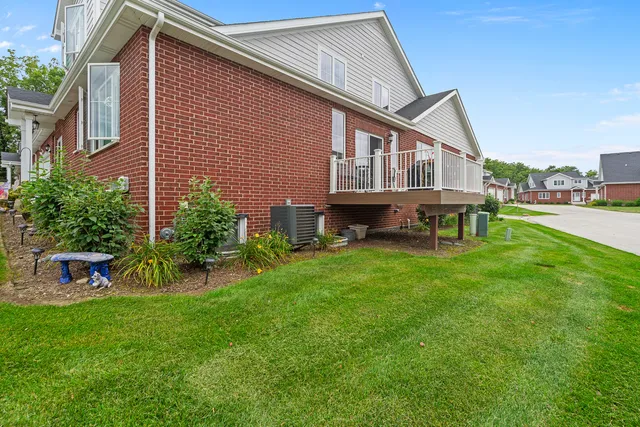 a view of a house with a yard and sitting area