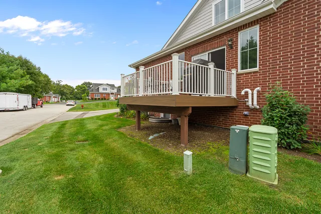 a backyard of a house with table and chairs