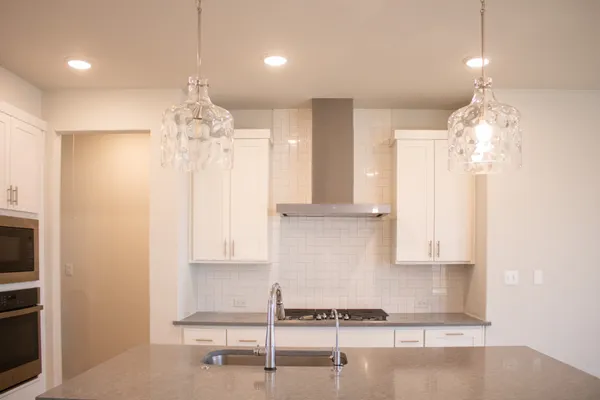 a view of kitchen with sink and refrigerator