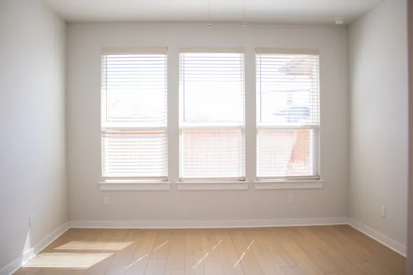 an empty room with closet and wooden floor