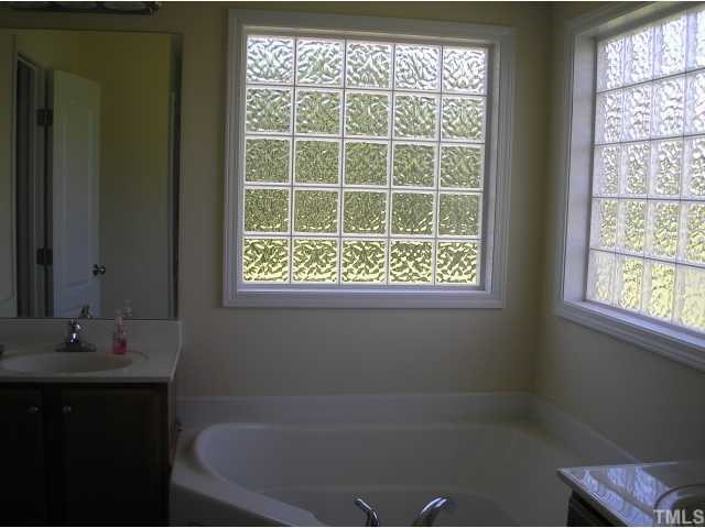 1518 Riley Court Stem, NC 27581 - Photo 8 of 10 a bathroom with a bathtub and a window
