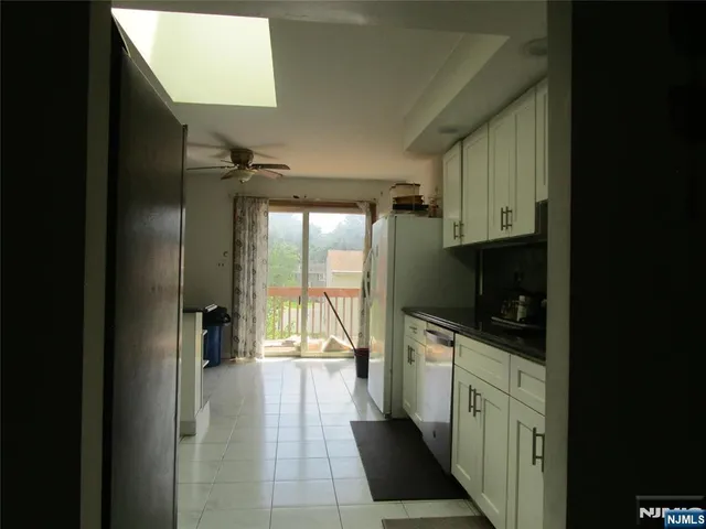 a kitchen with stainless steel appliances a sink stove and cabinets