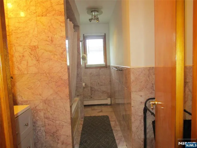 a bathroom with a granite countertop shower a sink and a toilet