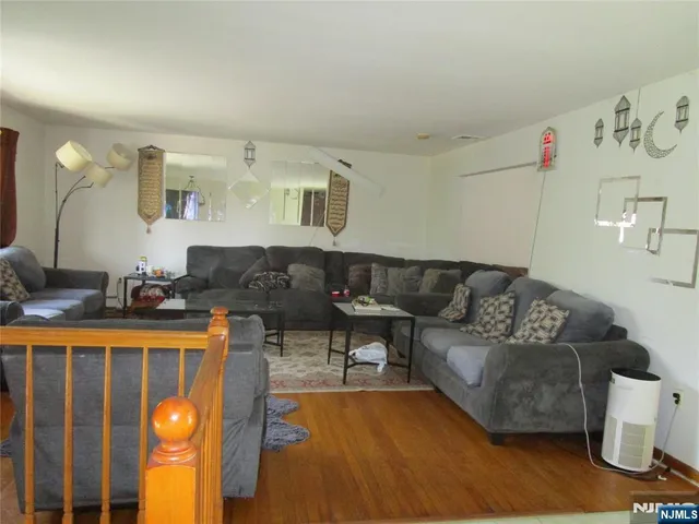 a living room with furniture and lamp