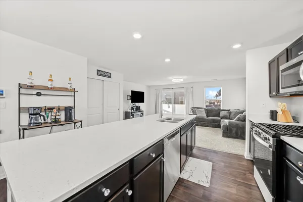 a kitchen with stainless steel appliances a sink and a refrigerator