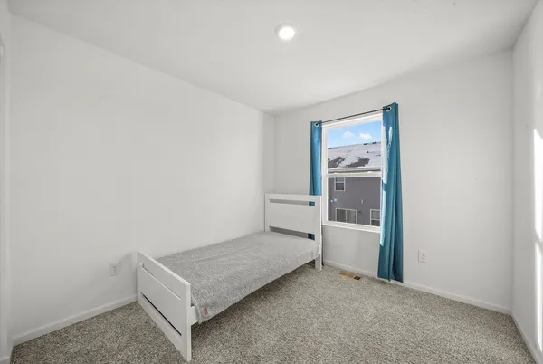 a living room with a bed and furniture