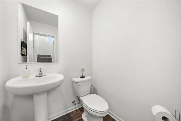 a white toilet sitting next to a bathroom sink