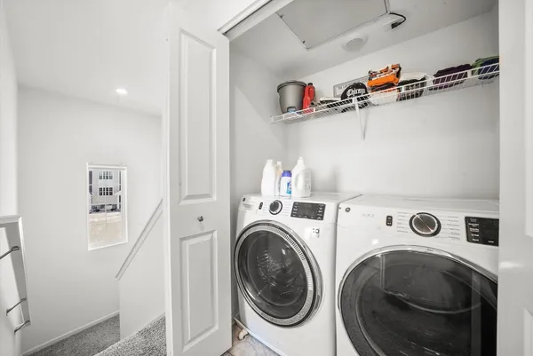 a view of storage and utility room with washer and dryer