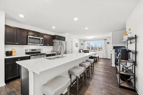 a large kitchen with a table and chairs