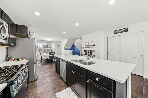 a kitchen with a sink stove and wooden cabinets
