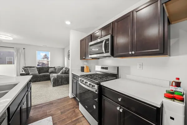 a kitchen with granite countertop stainless steel appliances and wooden cabinets