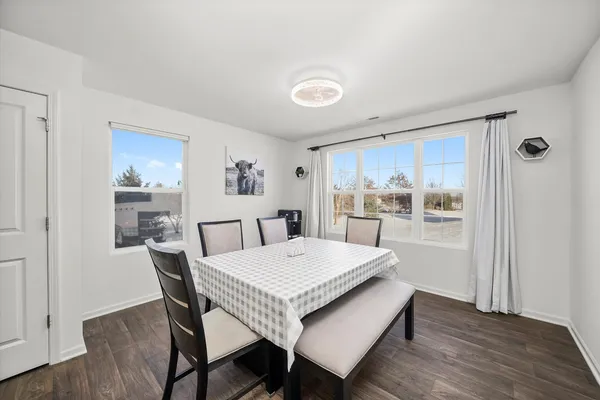 a view of a dining room with furniture window and wooden floor