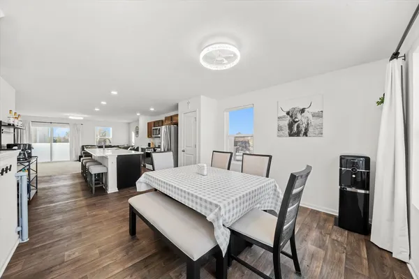 a view of a dining room with furniture and wooden floor