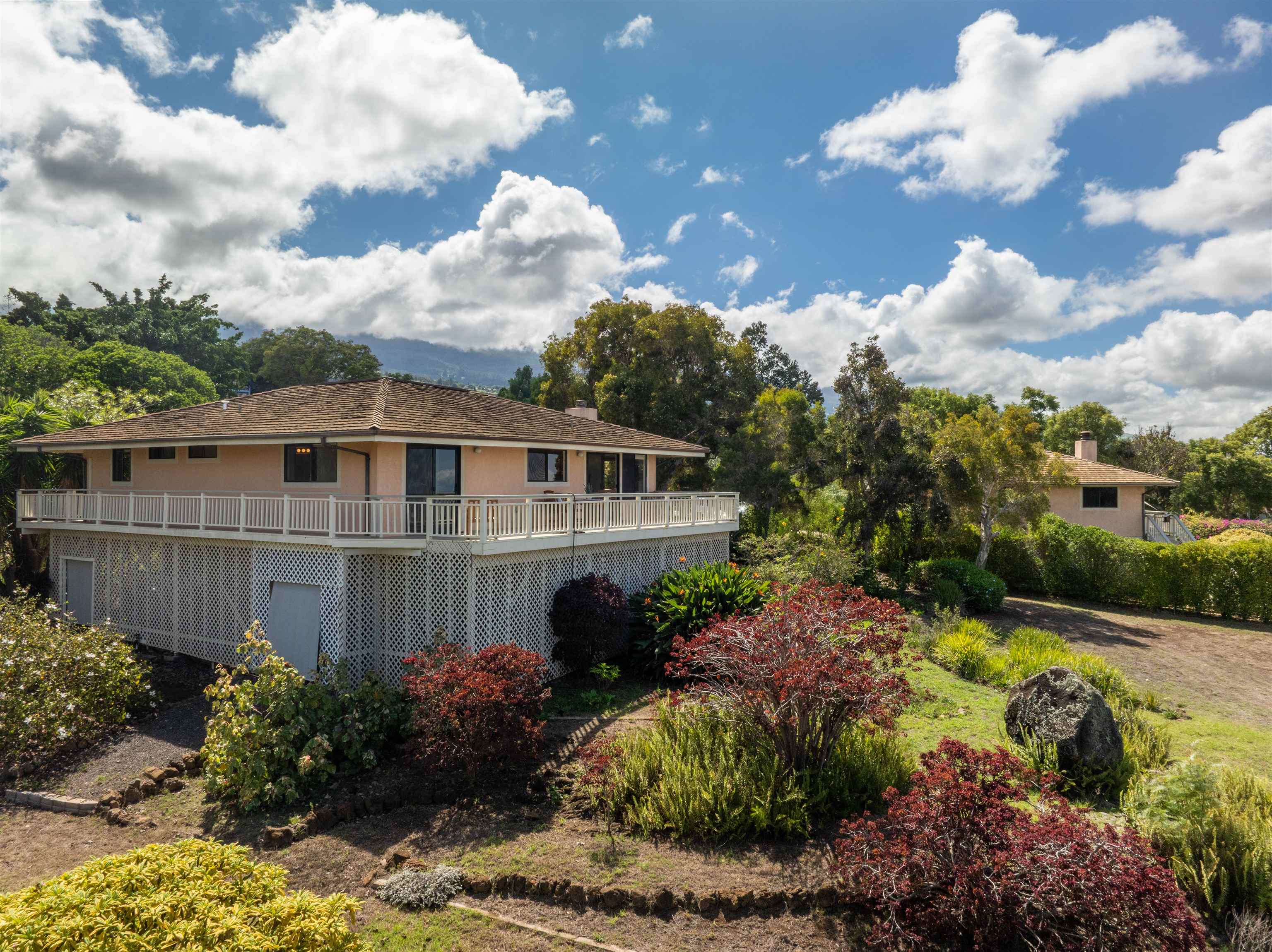358 Holopuni Road Kula, HI 96790 - Photo 33 of 49 a view of a house with a big yard and flower plants