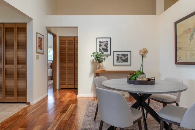 a dining room with furniture and wooden floor