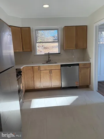 a kitchen with a sink and a refrigerator