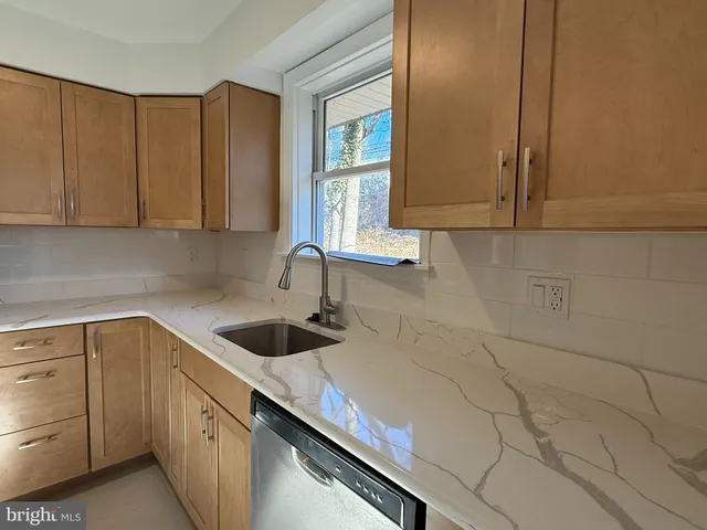 a kitchen with a sink cabinets and window