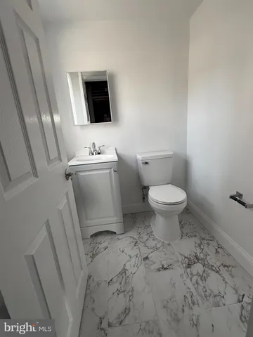 a bathroom with a sink toilet and mirror