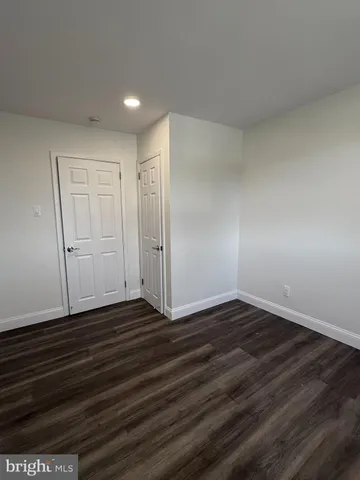 a view of an empty room and wooden floor