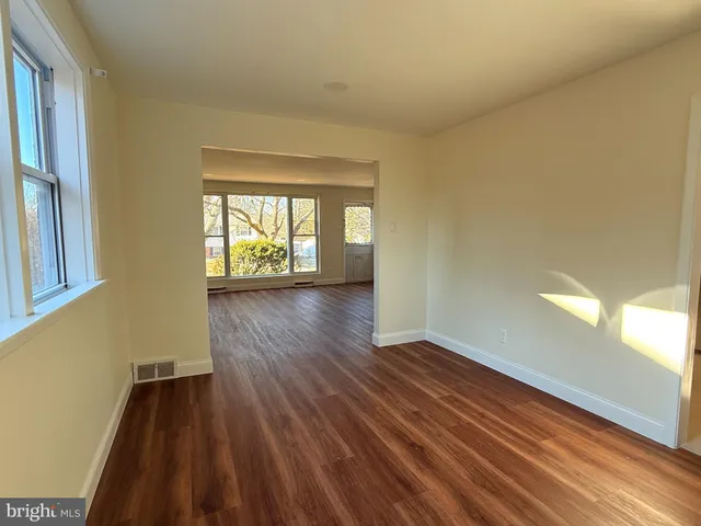 a view of an empty room and glass door