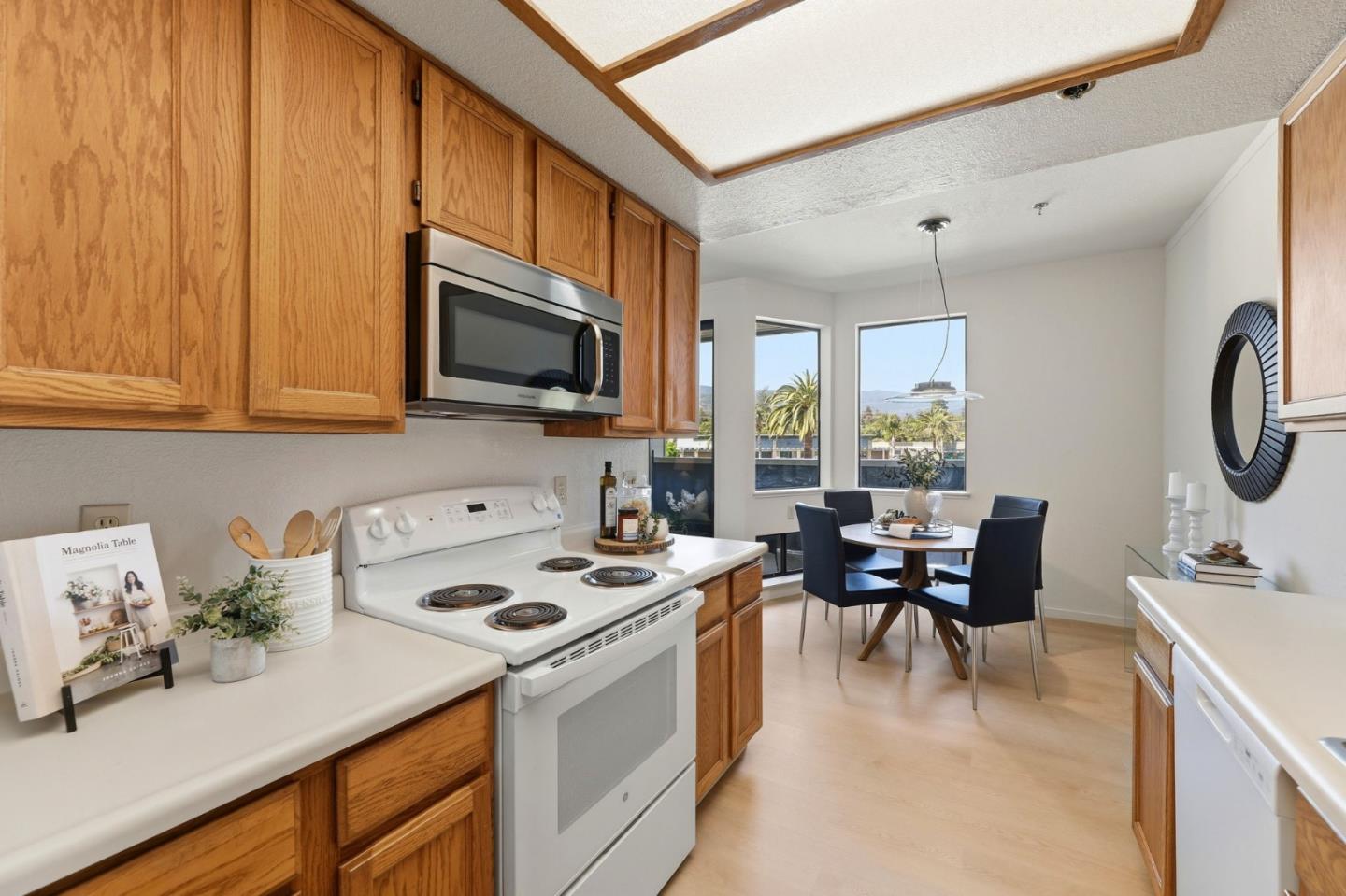 22330 Homestead Road, Unit 226 Cupertino, CA 95014 - Photo 14 of 38 a kitchen with a stove cabinets and living room view