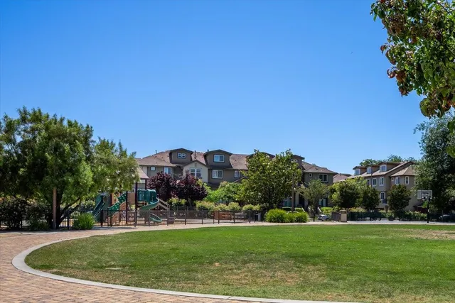 a view of a garden with a building in the background