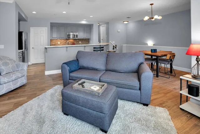 a living room with furniture and kitchen view