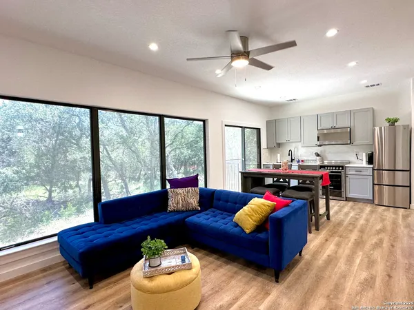 a living room with furniture and a floor to ceiling window
