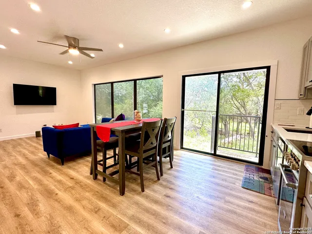 a view of a dining room with furniture window and wooden floor