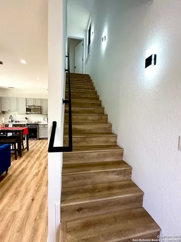 a view of entryway and hall with wooden floor