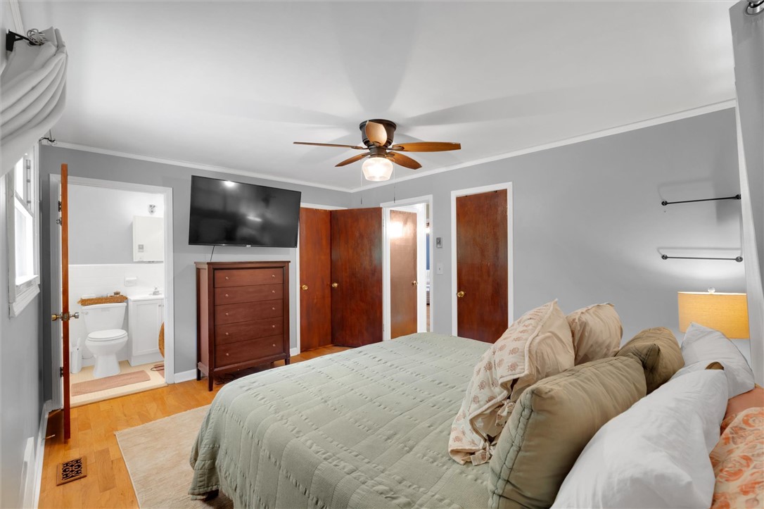 1815 Pearman Dairy Road Anderson, SC 29625 - Photo 16 of 35 Hardwood flooring and light grey walls define this comfortable, well-lit primary bedroom.