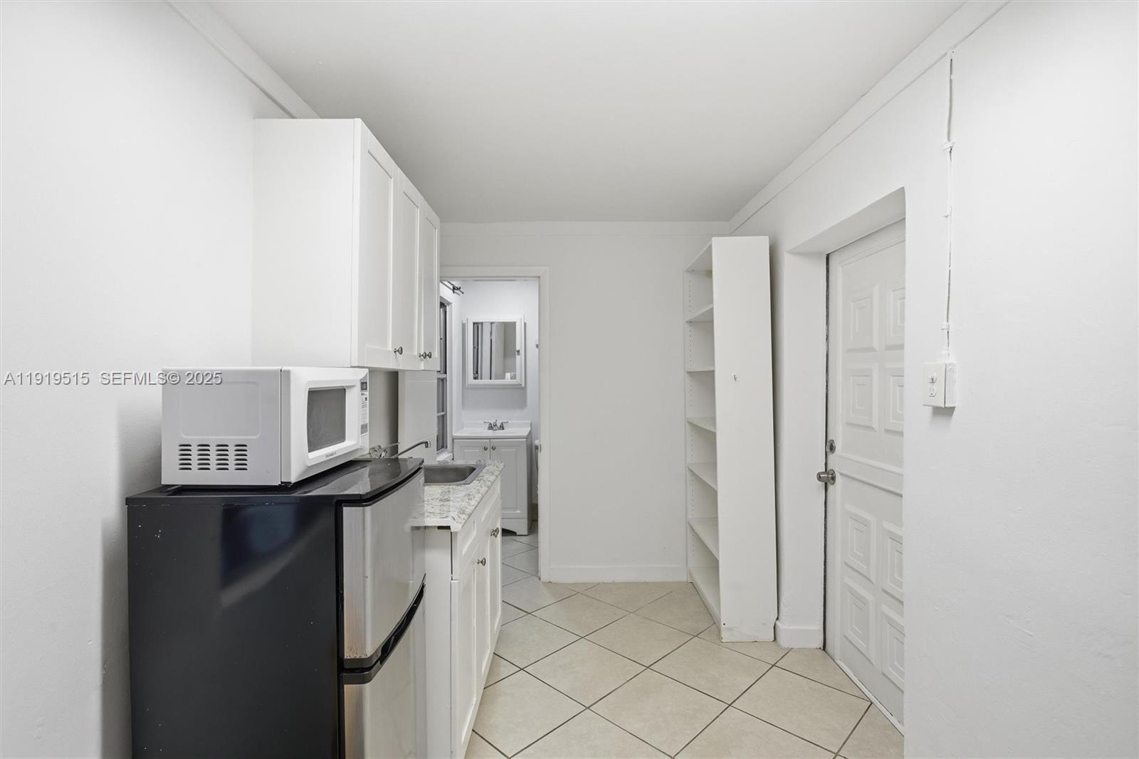 2445 Southwest 18th Street, Unit 5 Miami, FL 33145 - Photo 7 of 10 a kitchen with stainless steel appliances a sink and cabinets
