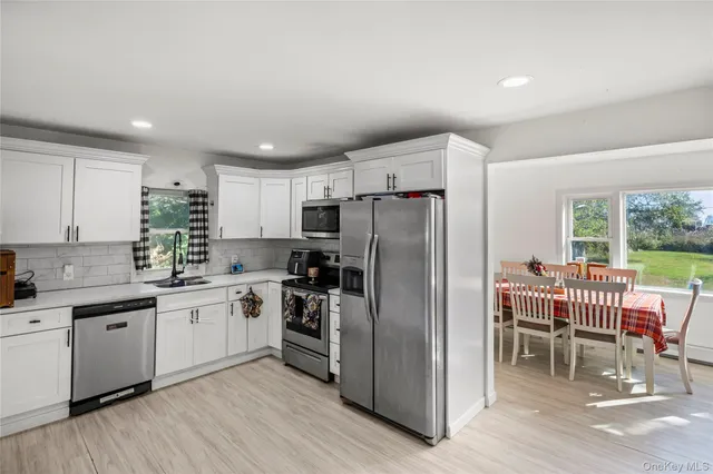 a kitchen with a sink appliances and cabinets