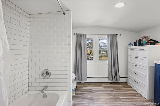 a bathroom with a bathtub and shower