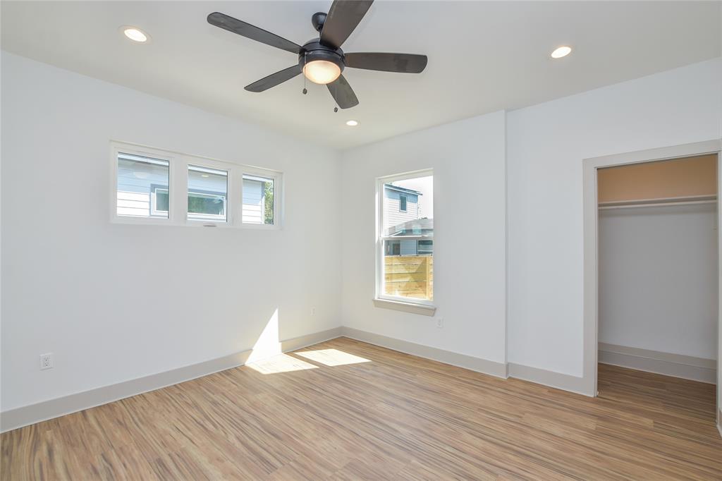 7103 Bennett Avenue, Unit 1 Austin, TX 78752 - Photo 11 of 25 a view of an empty room with wooden floor and a window