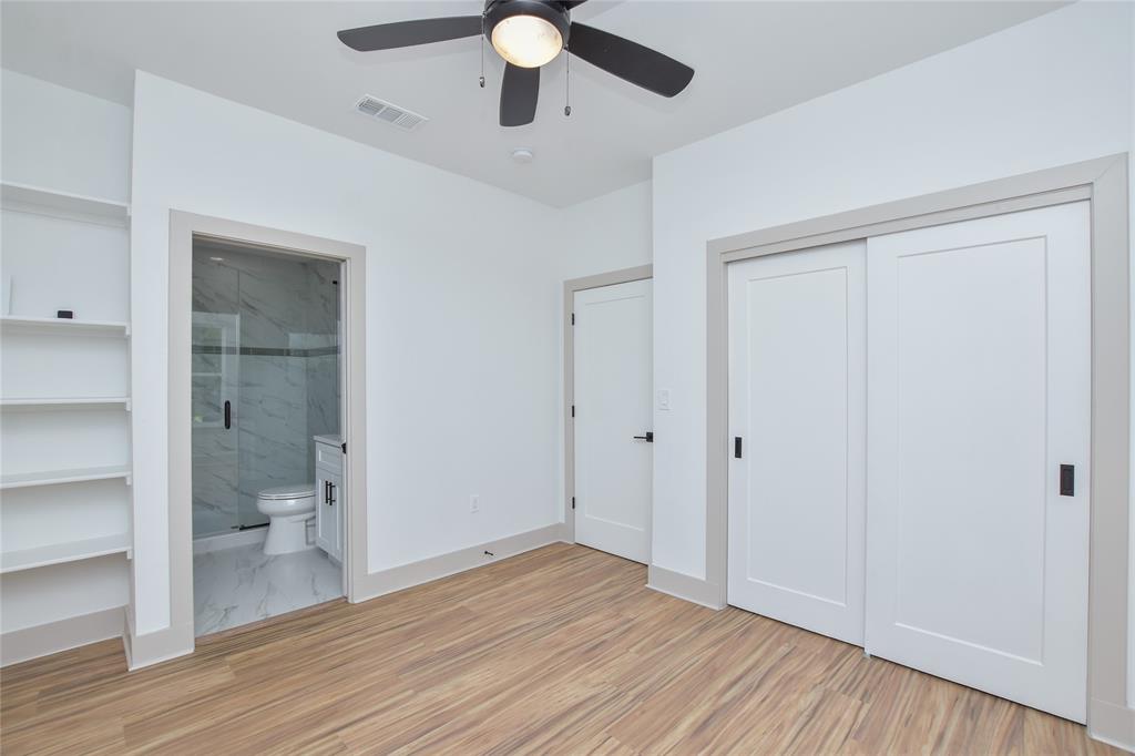 7103 Bennett Avenue, Unit 1 Austin, TX 78752 - Photo 16 of 25 wooden floor in an empty room with a bathroom