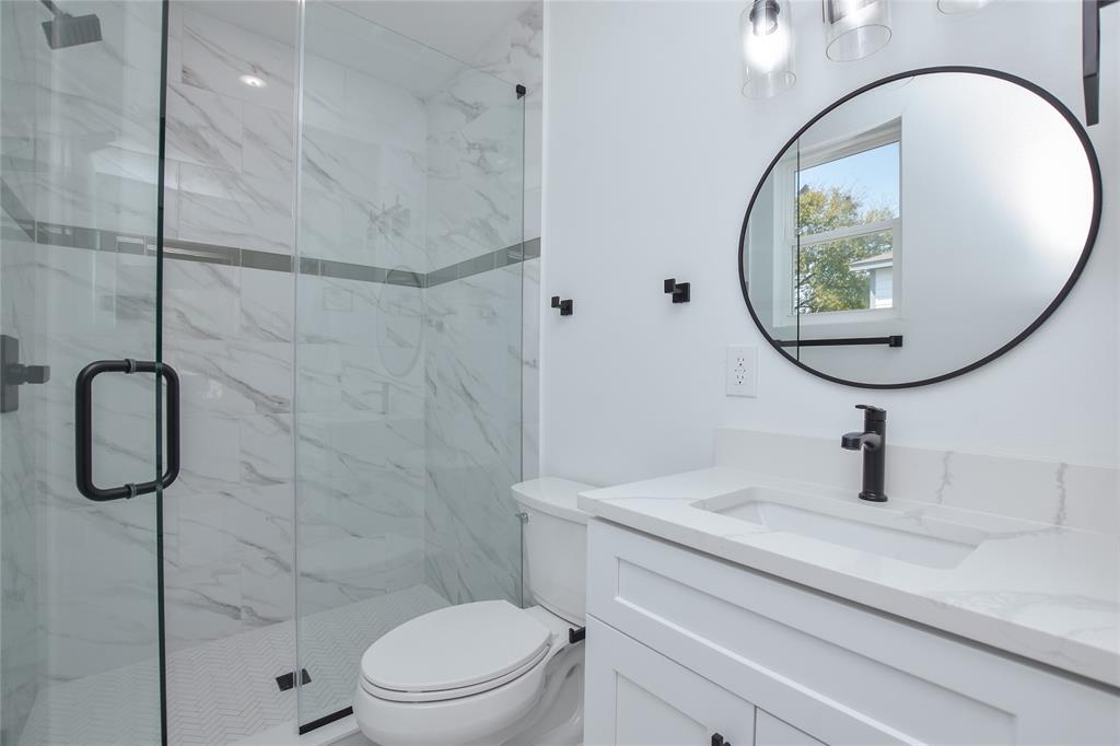 7103 Bennett Avenue, Unit 1 Austin, TX 78752 - Photo 17 of 25 a bathroom with a sink toilet and a mirror
