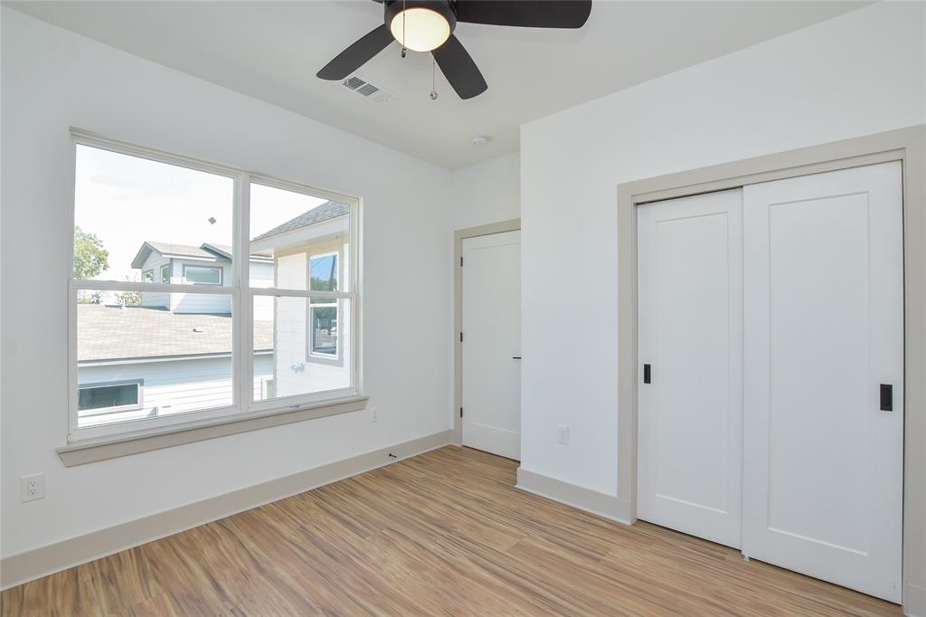 7103 Bennett Avenue, Unit 1 Austin, TX 78752 - Photo 18 of 25 a view of an empty room with wooden floor and a window