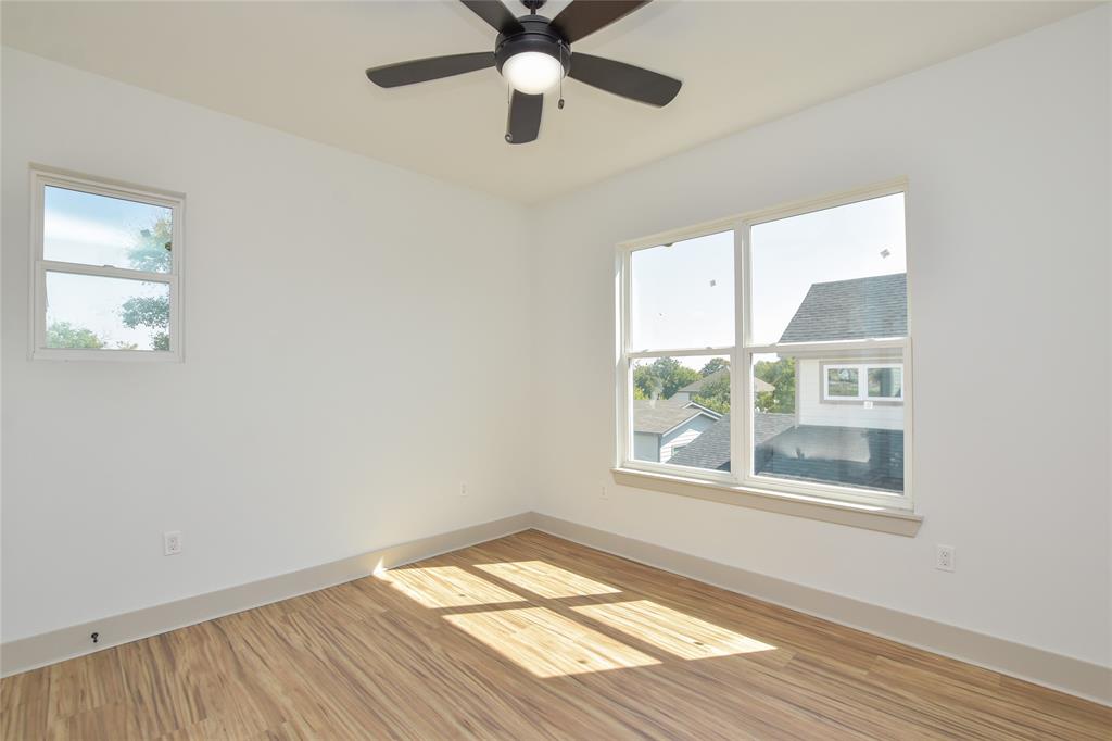 7103 Bennett Avenue, Unit 1 Austin, TX 78752 - Photo 23 of 25 a view of an empty room with wooden floor and a window